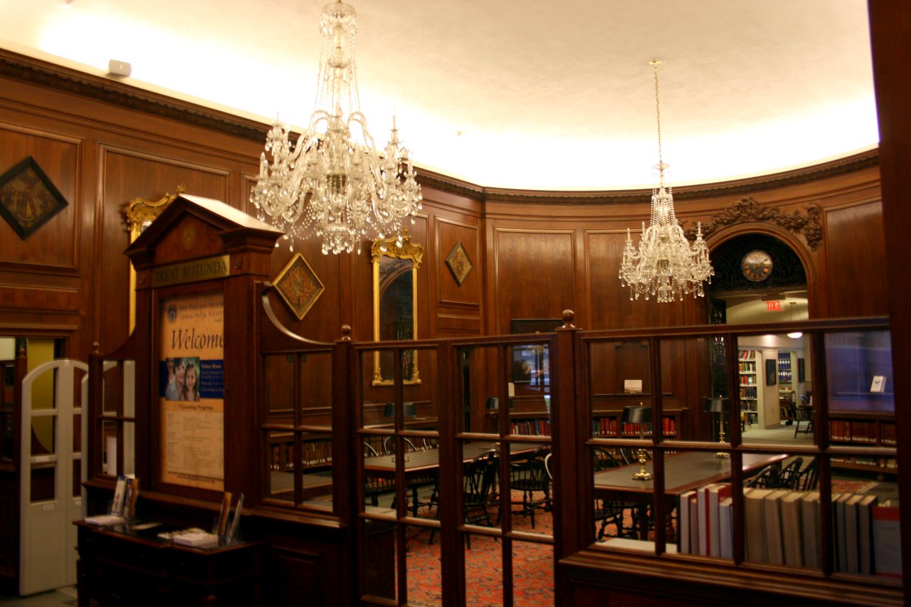 Wood-panelled reading room with chandeliers at the NEHGS
